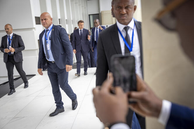 French President Emmanuel Macron and his Beninese counterpart Patrice Talon visit an exhibition in Cotonou on July 27, 2022.