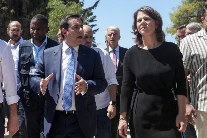 Greek Migration Minister Notis Mitarachi and German Foreign Minister Annalena Baerbock visit the Schisto refugee camp near Athens on July 28, 2022.
