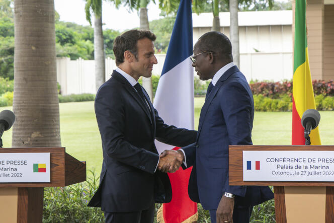 French President Emmanuel Macron, left, is welcomed by Benin President Patrice Talon at the presidency in Cotonou, Wednesday, July 27, 2022. 