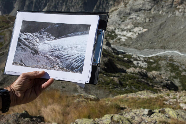 Thierry Maillet, heritage expert for the Ecrins national park, shows a 1983 photo of the Glacier Blanc taken at exactly the same place, in the direction of the mountain refuge on July 26.