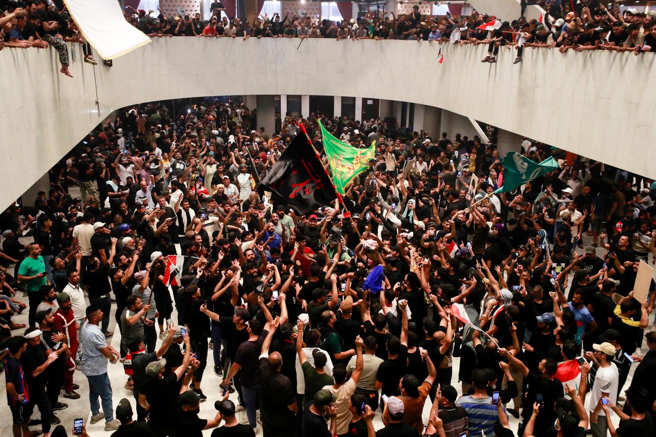 Supporters of Muqtada al-Sadr cheer as they enter the Iraqi parliament, located in the heavily-guarded Green Zone in the capital, Baghdad, on July 30, 2022.
