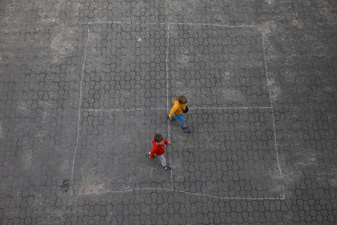 Ukrainian refugee children walk along the backyard of the Lauder Morasha Jewish school in Warsaw, on Thursday, July 28, 2022. 