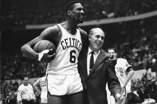 Boston Celtics star Bill Russell (left) congratulated by coach Arnold Auerbach after scoring his 10,000 NBA point in Boston on December 12, 1964.