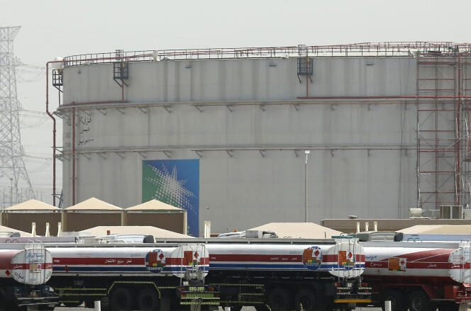 Fuel trucks line up in front of storage tanks at the Aramco refinery in northern Jeddah, Saudi Arabia, on March 21, 2021. 