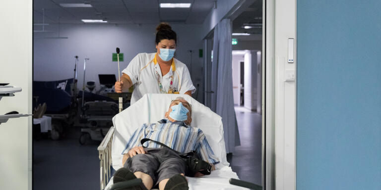 Laetitia Preaud, a nurse's aide, transfers a patient to the waiting room of the emergency room of the Centre hospitalier départemental (CHD Vendée) in La Roche-sur-Yon.