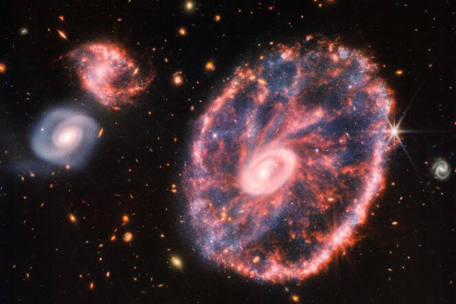 Composite image taken by the James Webb Space Telescope, showing the Cartwheel Galaxy and its companion galaxies.