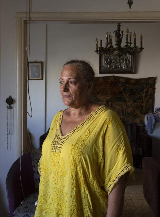 Fadia Zaarour stands in the living room at her apartment in Karantina, a neighbourhood in Beirut facing the port, Lebanon, Tuesday, August 2, 2022. On August 4, Fadia had just come back home from work and was standing in the living room facing the window when the double explosion shook the capital.