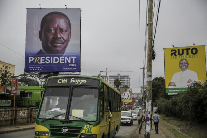 A bus passes banners of Kenyan presidential candidates Raila Odinga, left, and William Ruto, right, on a road in Nairobi's Mathare slum, Monday, Aug. 1, 2022.