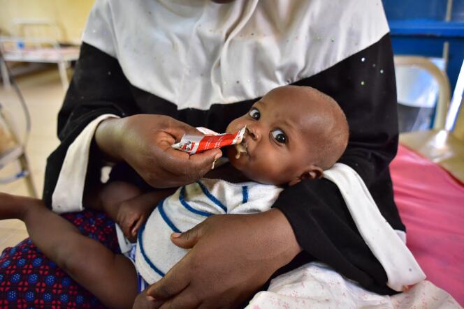 A malnourished child is fed plumby nut at a hospital in Niamey, Niger, in June 2016.