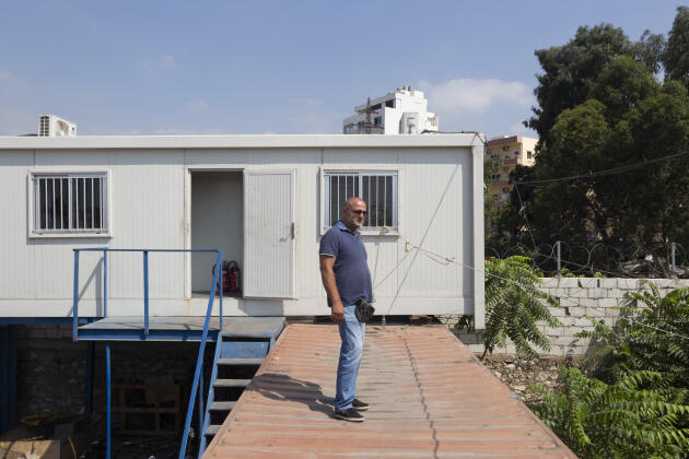 Imad Costantine stands on a container in front of his office in Karantina, a neighborhood in Beirut facing the port, Lebanon, Tuesday, August 2, 2022.