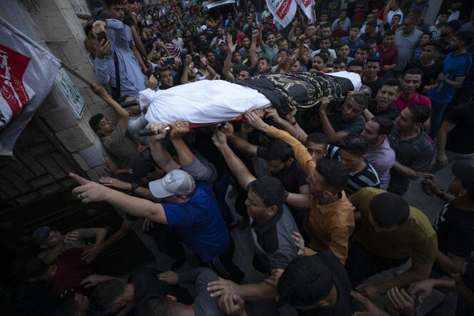 Palestinian mourners carry the bodies of victims killed in an Israeli airstrike