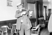 Lieutenant William Shoemacher stands and aims a Thompson machine gun, or Tommy gun, Chicago, 1926. 