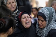 Relatives mourn four Palestinian teenagers killed by Israeli bombs, at the funerals in Jabaliya, northern Gaza Strip, August 8, 2022.