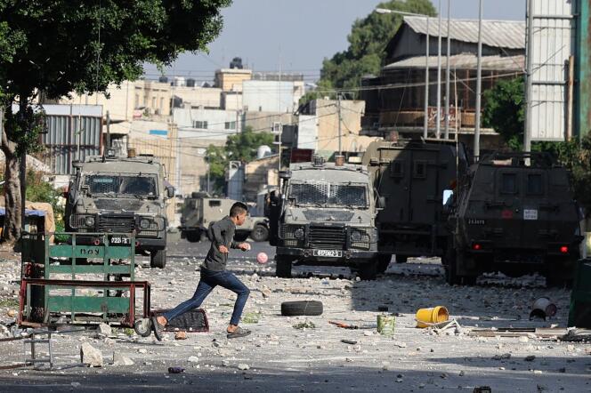 Israeli security forces vehicles take position during a raid in the old town of Nablus, in the occupied West Bank, on August 9, 2022.