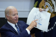American President Joe Biden shows a wind turbine size comparison chart during a meeting in the Roosevelt Room of the White House. June 23, 2022. 