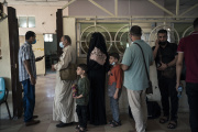 Palestinians line up to have their documents checked before crossing the Rafah border with Egypt in the southern Gaza Strip on June 6, 2021.