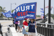 Trump supporters carry flags near Mar-a-Lago in Palm Beach, Florida, on Aug. 9, 2022.