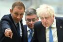 Britain's Prime Minister Boris Johnson (R) listens to Head of Broughton plant at Airbus Jerome Blandin (L) next to Secretary of State for Wales Robert Buckland (C) during a visit of the division manufacturing the wings for the A350 as part of a tour of the Broughton Airbus plant, in Chester, north of Wales, on August 12, 2022. (Photo by Oli SCARFF / POOL / AFP)