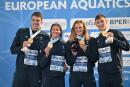 (From L) France's Charles Rihoux, Charlotte Bonnet, Marie Wattel and Maxime Grousset pose on the podium after winning the Mixed 4 x 100m freestyle final event on August 15, 2022 during the LEN European Aquatics Championships in Rome. (Photo by Alberto PIZZOLI / AFP)