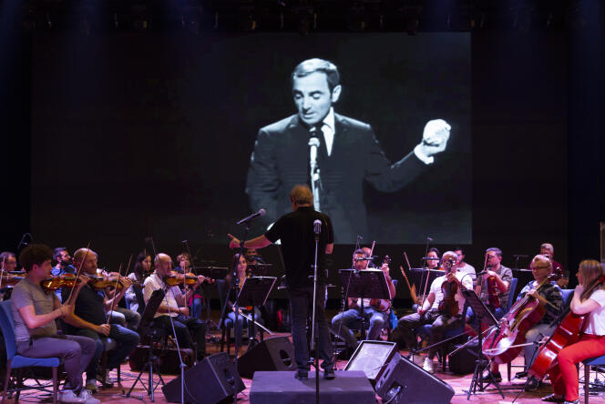 Le maestro Harout Fazlian (au centre, de dos), avec l’Orchestre philharmonique du Liban, le 16 août 2022, lors d’une répétition du concert en hommage à Charles Aznavour au Casino du Liban à Maameltein, au nord de Beyrouth.