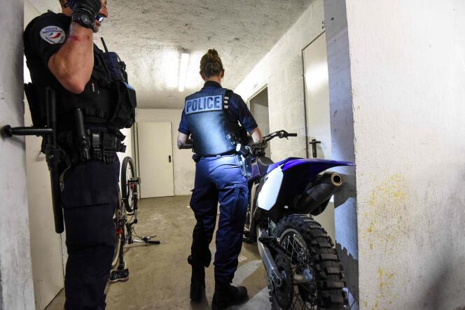 Police officers inspect a motorcycle as part of an investigation into urban rodeos, in Nantes, on August 11, 2022. 