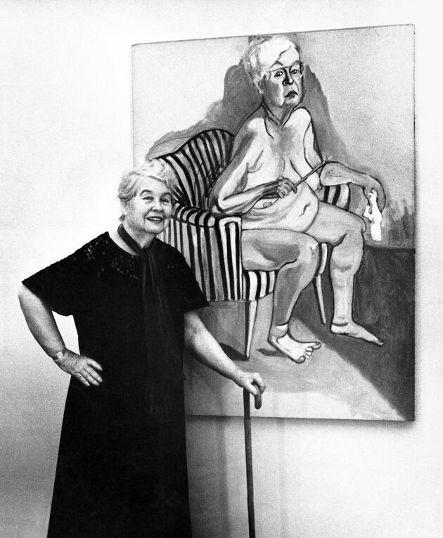 Alice Neel, posing in front of her self-portrait (1980), in New York, in 1981.