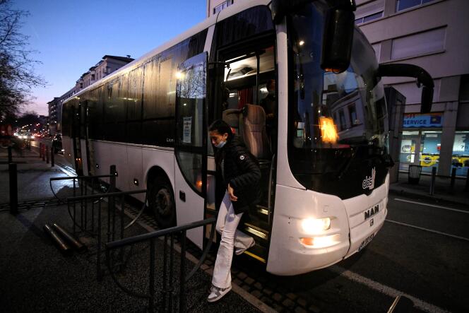 A student gets off the bus that takes her to her school, in the Saint-Michel district, in Toulouse, on February 8, 2022.