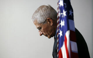 FILE - Dr. Anthony Fauci, director of the National Institute of Allergy and Infectious Diseases, listens as President Donald Trump speaks during a coronavirus task force briefing at the White House, April 4, 2020, in Washington. Fauci, the nation's top infectious disease expert who became a household name, and the subject of partisan attacks, during the COVID-19 pandemic, announced Monday he will depart the federal government in December after more than 5 decades of service. (AP Photo/Patrick Semansky)