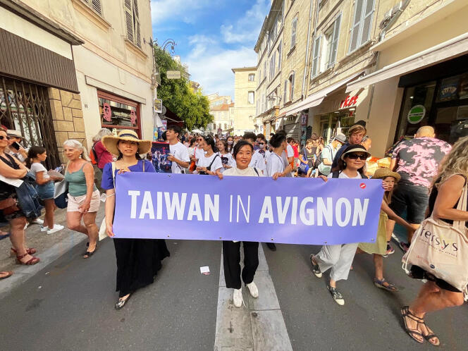 Hu Ching-fang (center) parades in the streets of Avignon with Taiwanese theater companies, July 6, 2022.