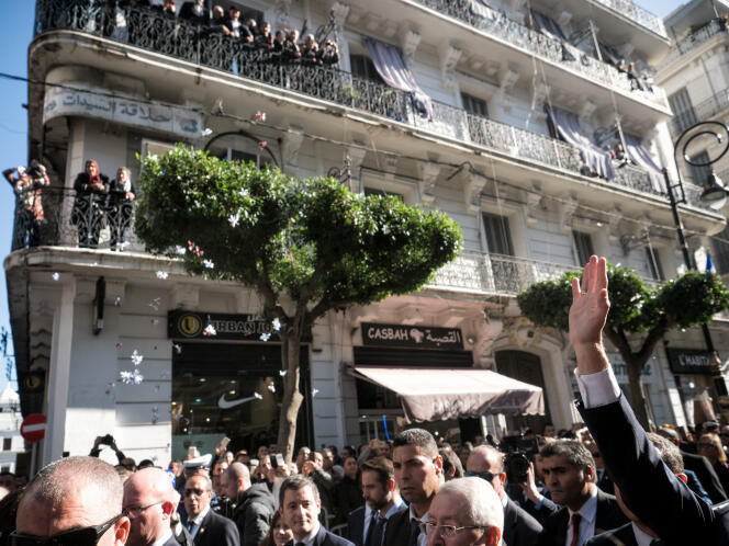 Emmanuel Macron greets the crowd during his first visit to the country as head of state, in Algiers, December 6, 2017.