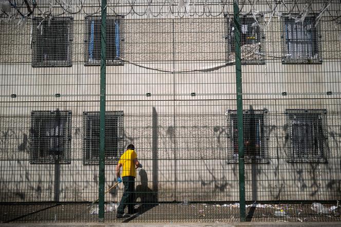 An inmate cleans an outside hallway at the Toulouse-Seysses detention center in Seysses on May 10, 2022.