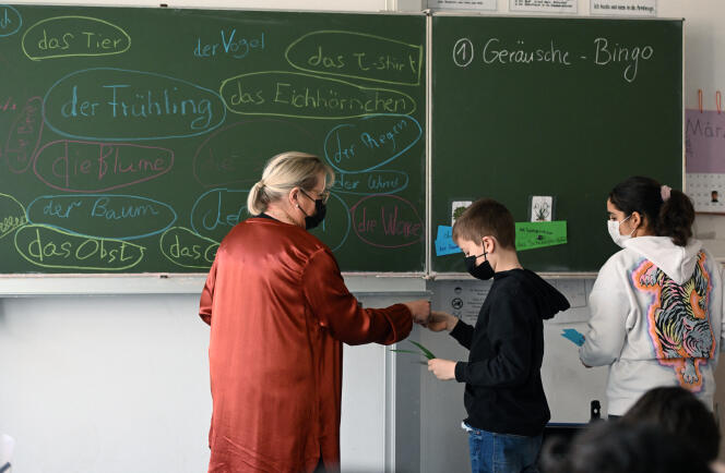 A teacher (left) talks to a Ukrainian student during an international class at the Max-Ernst comprehensive school in Cologne, Germany, March 25, 2022.