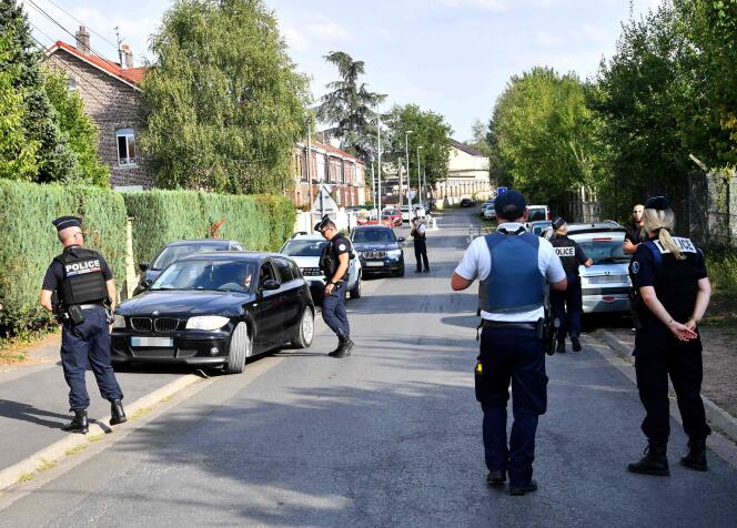 Police officers check a car in the street where there is a house belonging to the family of Imam Hassan Iquioussen, in Lourches (North), August 30, 2022. 