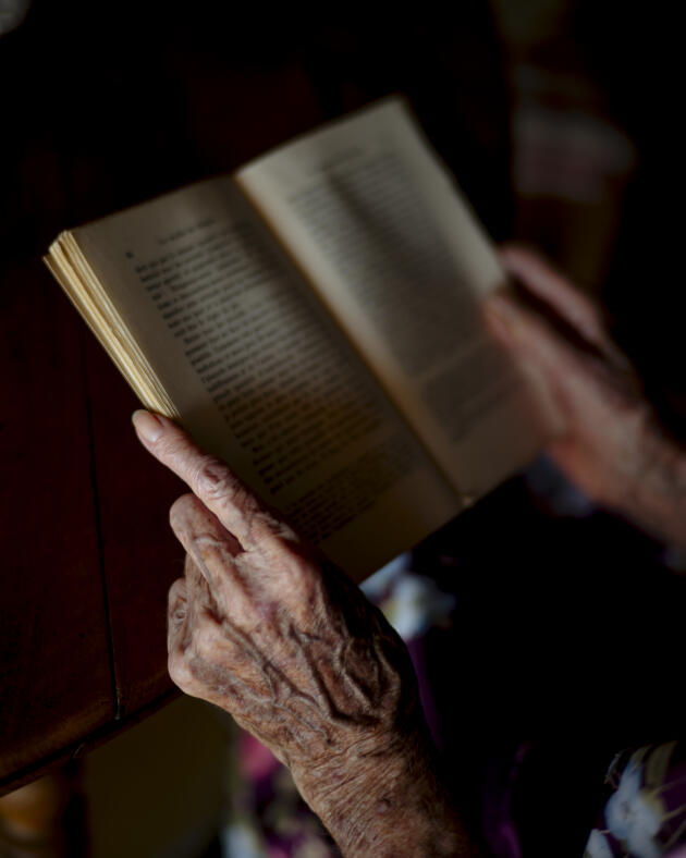 Cécile Colonna, Yvan Colonna's mother, holding one of her son's books, in the family home in Cargèse, Corse-du-Sud, August 11, 2022.