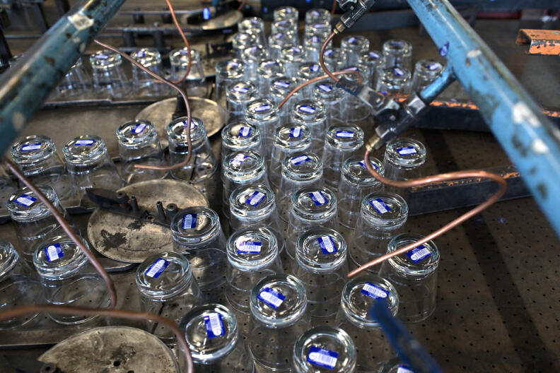 Glasses are pictured at the end of a production line at a factory of French manufacturer of glassware Duralex in La Chapelle-Saint-Mesmin near Orleans, centre France, on July 1, 2021, during a visit of the French Junior Minister of Small and Medium Entreprises. (Photo by GUILLAUME SOUVANT / AFP)