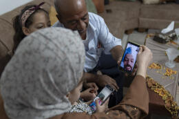 Khalil Awawdeh, a Palestinian detainee in Israel, talks to family members on a video call, at their family house in the West Bank village of Idna, Hebron, Monday, Aug. 22, 2022. Israel's Supreme Court on Monday rejected an appeal to release Awawdeh who has been on a hunger strike for several months to protest his detention without charge. (AP Photo/Nasser Nasser)