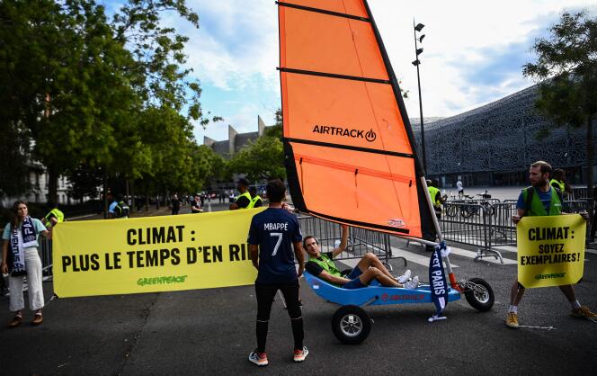 Environmental activists from the NGO Greenpeace carry out an operation near the Parc des Princes, in Paris, on September 6, in reaction to comments made by the coach of the PSG soccer team, Christophe Galtier, about air travel.