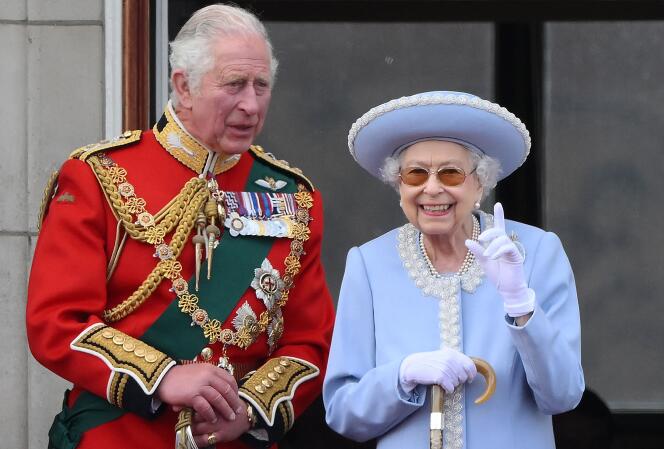 In this file photo taken on June 02, 2022 Queen Elizabeth II stands with Britain's Prince Charles to watch a special flypast from Buckingham Palace balcony following the Queen's Birthday Parade. 