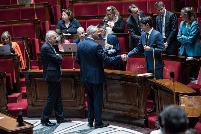 Finance Minister Bruno Le Maire shakes hands with Budget Minister Gabriel Attal at the Assemblée Nationale on July 22, 2022.