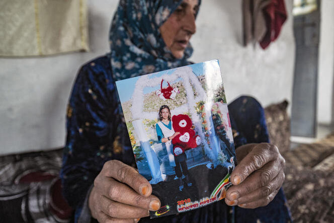 Shawafa Khodr holds a photo of her missing daughter, Jenda Saeed (27), at her home in the village of Batirzan, in the countryside of the northeastern Syrian province of Hasakah, on May 4, 2022.