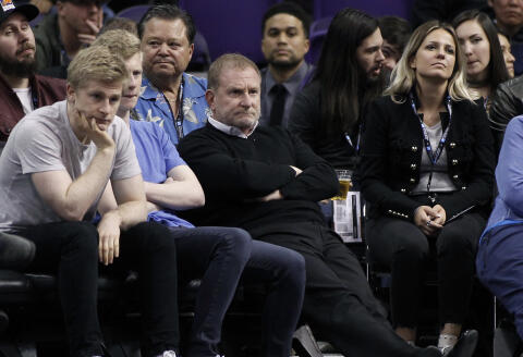 FILE - Phoenix Suns owner Robert Sarver, center, watches during the second half of an NBA basketball game against the Minnesota Timberwolves, Saturday, Dec. 15, 2018, in Phoenix. The NBA has suspended Phoenix Suns and Phoenix Mercury owner Robert Sarver for one year, plus fined him $10 million, after an investigation found that he had engaged in what the league called “workplace misconduct and organizational deficiencies." The findings of the league's report, published Tuesday, Sept. 13, 2022, came nearly a year after the NBA asked a law firm to investigate allegations that Sarver had a history of racist, misogynistic and hostile incidents over his nearly two-decade tenure overseeing the franchise. (AP Photo/Ralph Freso, File)