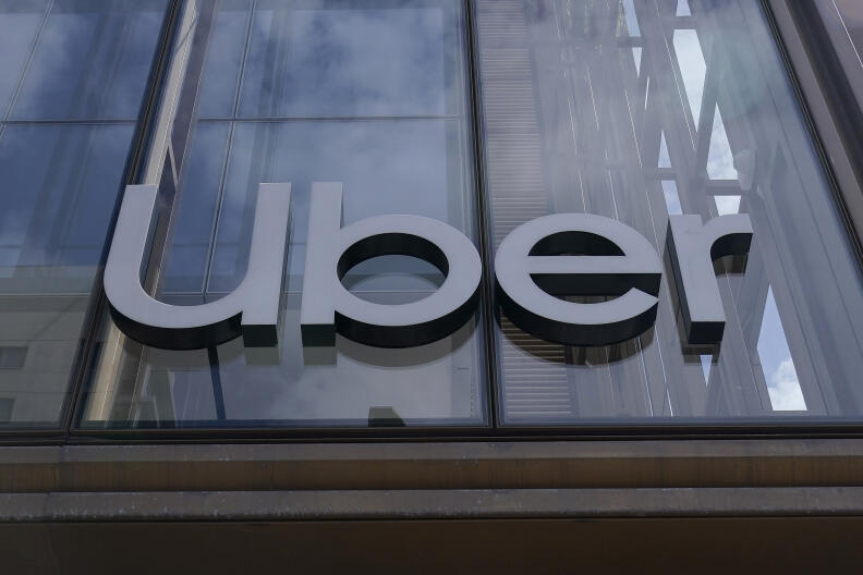 FILE - An Uber sign is displayed at the company's headquarters in San Francisco, Monday, Sept. 12, 2022. Uber said Thursday, Sept. 15, that it reached out to law enforcement after a hacker apparently breached its network. A security engineer said the intruder provided evidence of obtaining access to crucial systems at the ride-hailing service. (AP Photo/Jeff Chiu, File)