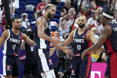 From left, Elie Okobo, Rudy Gobert, Evan Fournier and Guerschon Yabusele of France during the Eurobasket semi final basketball match between Poland and France in Berlin, Germany, Friday, Sept. 16, 2022. (AP Photo/Michael Sohn)