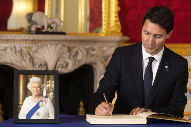 Canadian Prime Minister Justin Trudeau signs a book of condolences in memory of Queen Elizabeth II at Lancaster House in London on September 17, 2022.