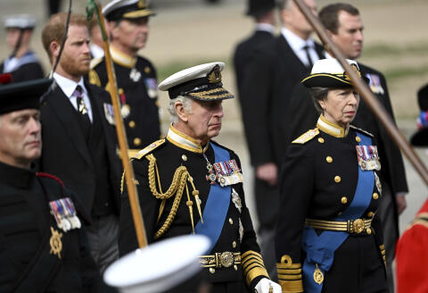 King Charles III, Princess Royale Anne, right, and Prince Harry, Duke of Sussex, left in the background, follow the procession for the state funeral of Queen Elizabeth II Monday, Sept. 19, 2022. The Queen, who died aged 96 on Sept. 8, will be buried in the George VI Memorial Chapel at Windsor alongside her late husband, Prince Philip, who died last year. (Jeff Spicer/Pool Photo via AP)