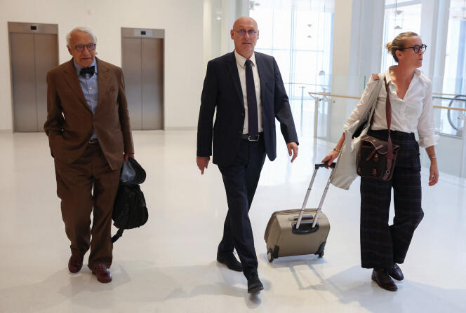 French Rugby Federation president, Bernard Laporte, arrives at the Paris Criminal Court flanked by his lawyers, September 7, 2022.