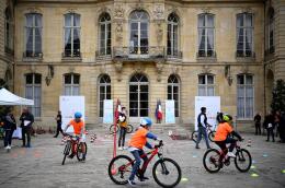 Children cycle on a course during an event held on the four-year mark of the "Plan Velo" cycling infrastructure development programme at the Hotel Matignon in Paris on September 20, 2022. The national cycling plan launched in 2018 and running to 2027 will be endowed with 250 million euros for 2023 to develop infrastructure and parking. (Photo by Christophe ARCHAMBAULT / AFP)