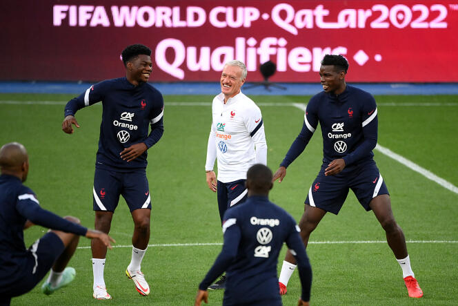 Coach Didier Deschamps jokes with Paul Pogba (right) and Aurélien Tchouameni (left) during training at the Olympic Stadium in kyiv on September 3, 2021.