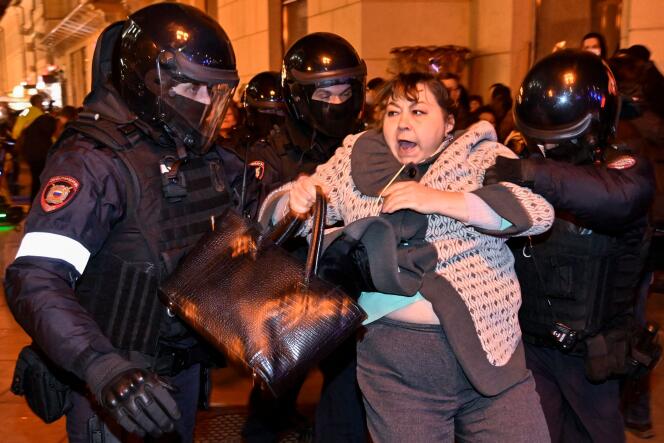 Police detain a woman in Moscow on September 21 at a protest against the call-up announced by President Vladimir Putin