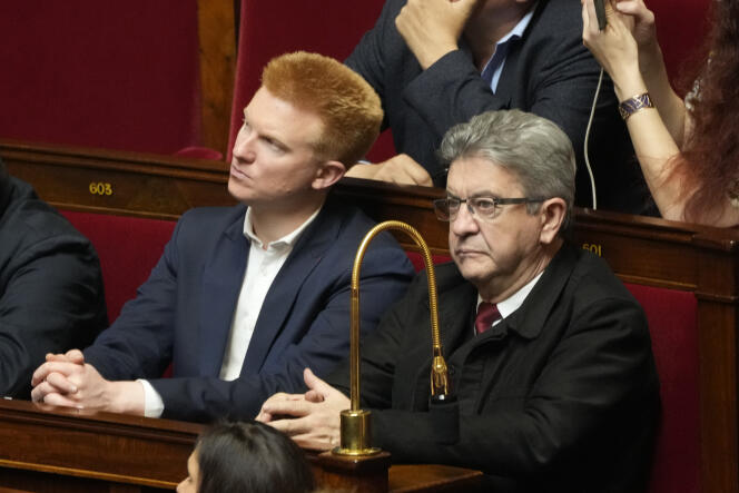 French left leader Jean-Luc Melenchon, right, and MP Adrien Quatennens listen to Ukrainian President Volodymyr Zelensky addressing the French Assemblée Nationale on March 23, 2022, in Paris. Mr. Quatennens recently acknowledged slapping his wife and Mr. Melenchon initially defended him.